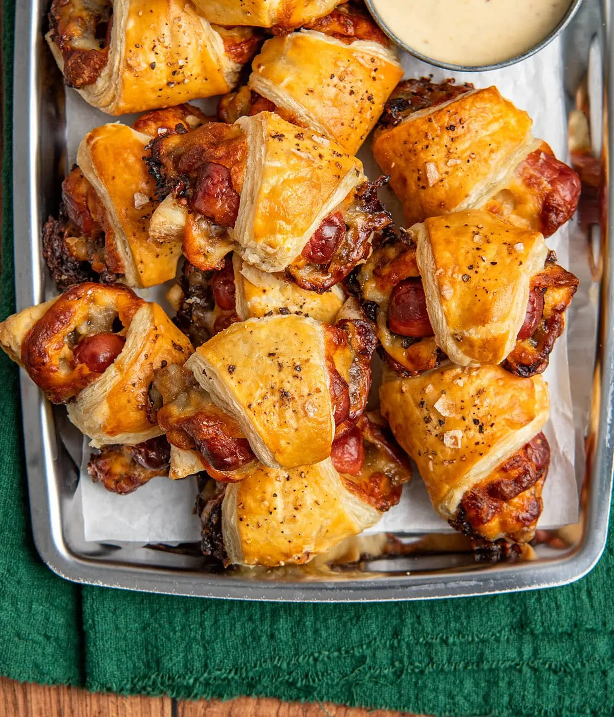 Elevated Pigs in a Blanket – Shattered-Gold Crust with a High-Gloss Ebony Mirror